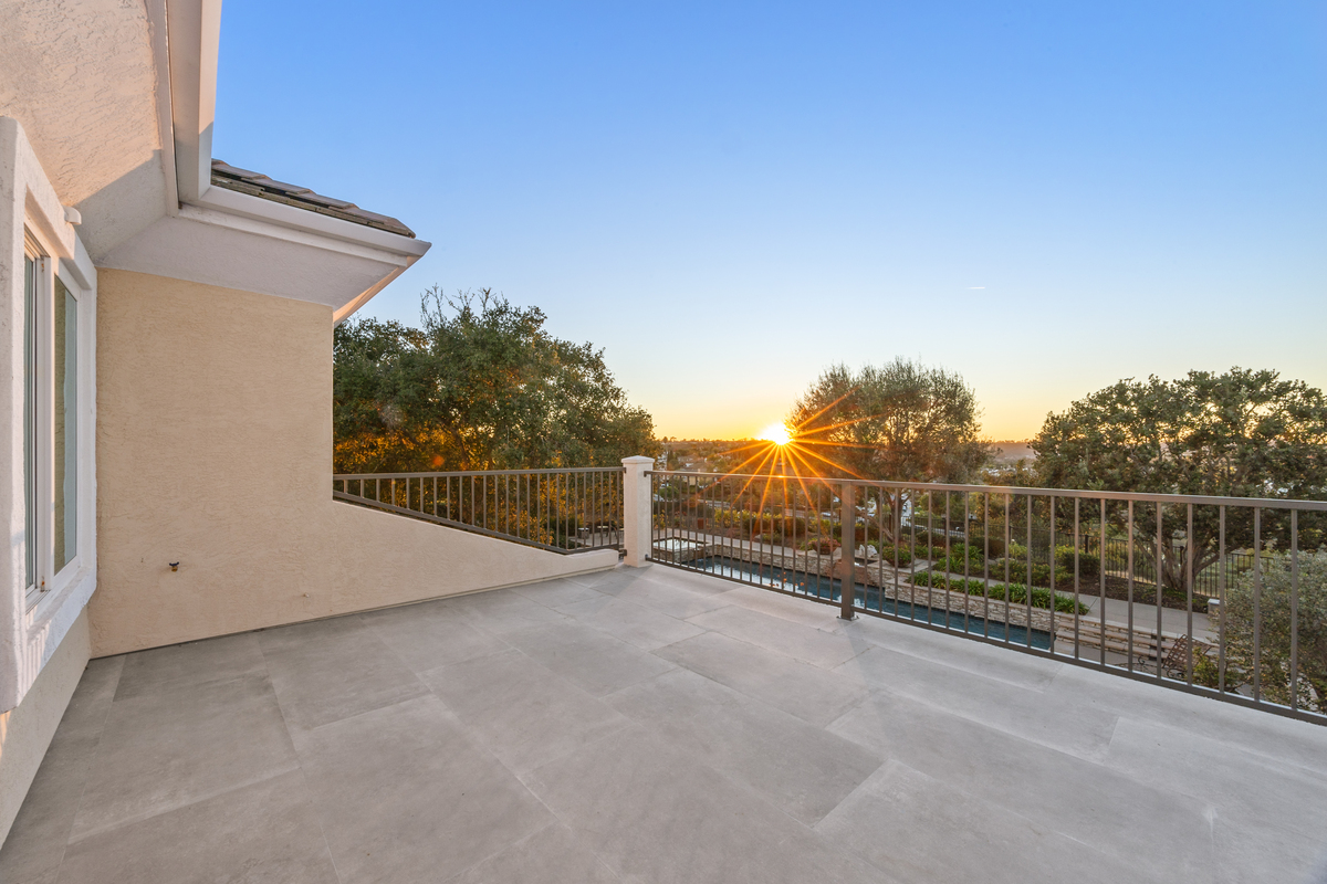 Modern La Costa home remodel in Carlsbad featuring a custom patio, outdoor seating area, and luxury backyard design.