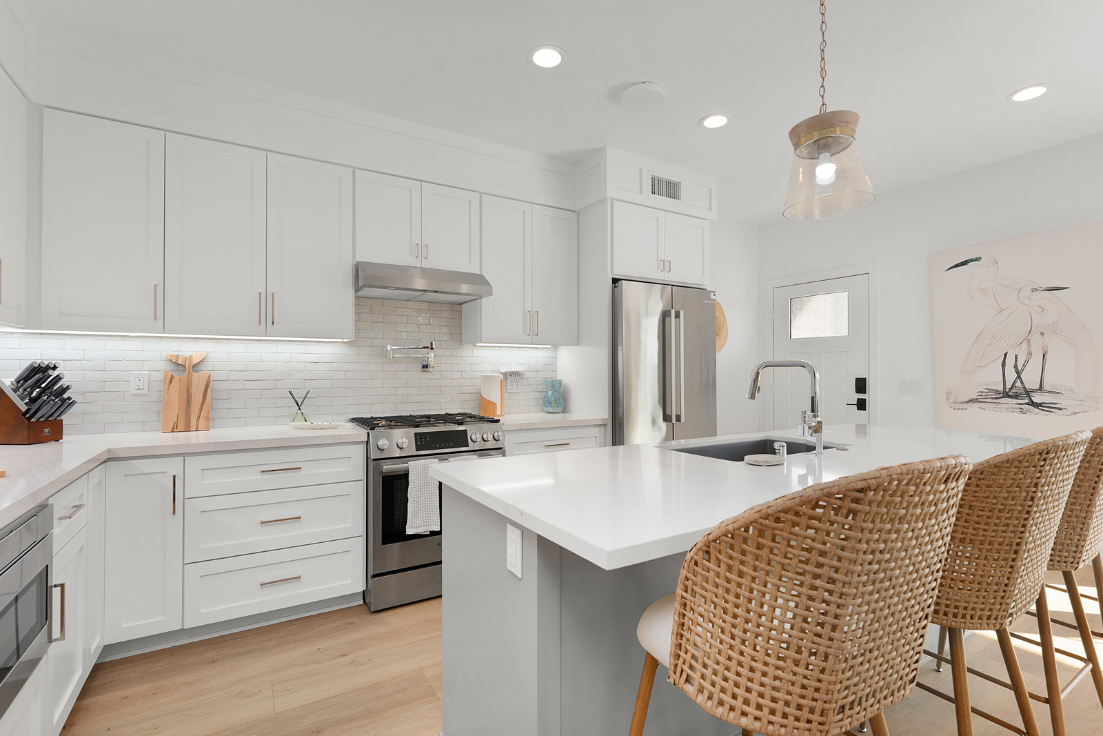 Spacious custom kitchen featuring quartz countertops, stainless steel appliances, and large island in a San Diego luxury home.