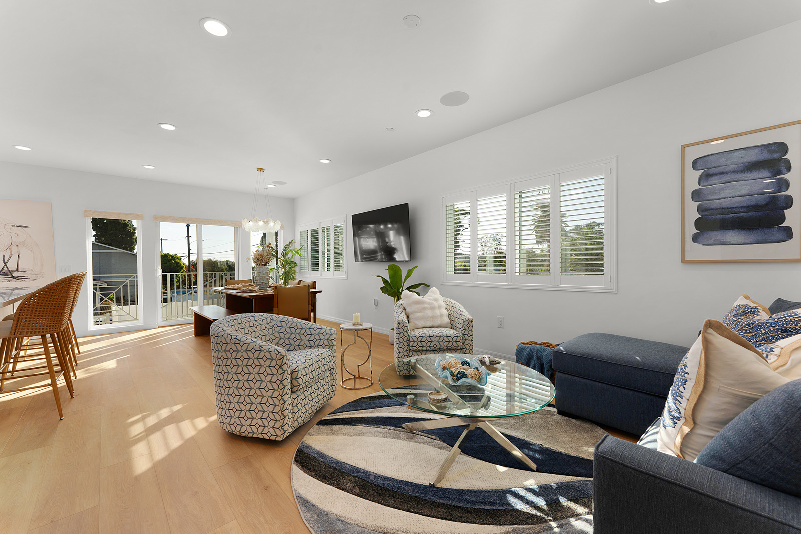 Family room with contemporary seating and open layout in a luxury San Diego new construction home.